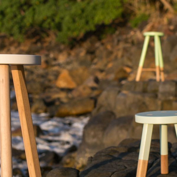 Green Cathedral Babanees stools at the beach on a rocky shoreline